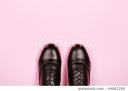 Pair of black shoes on pink pastel background. 44861209