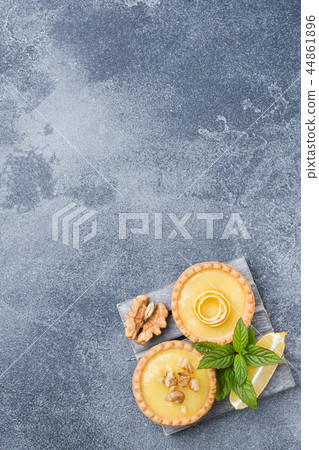 Homemade lemon curd in tartlets with fresh lemon  44861896
