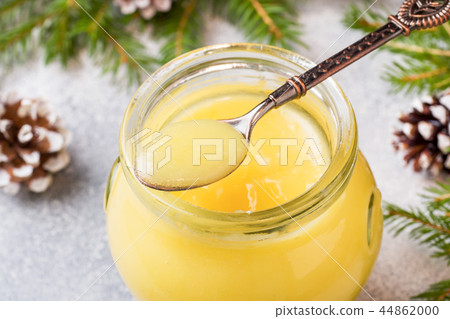 Homemade lemon curd in glass jars on the table.  44862000
