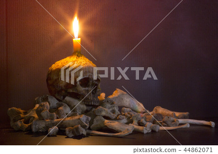 Candlestick skull and bones on dark background 44862071
