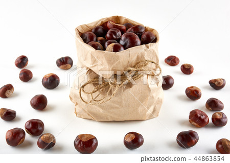 Chestnuts in paper bag on white background 44863854