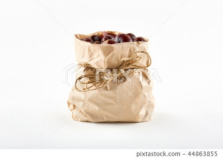 Chestnuts in paper bag on white background 44863855