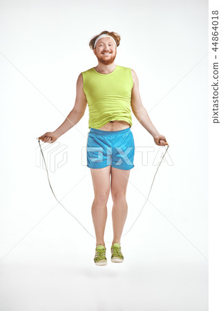 Red haired, bearded, plump man holding skipping rope Red haired, bearded, plump man holding skipping rope 44864018