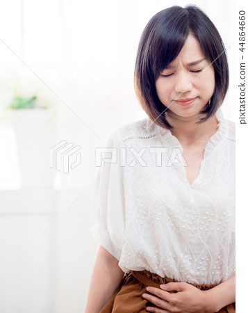 Young woman suffering from menstrual cramps 44864660