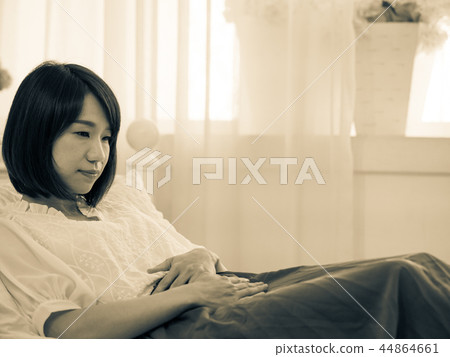 Young woman suffering from menstrual cramps 44864661