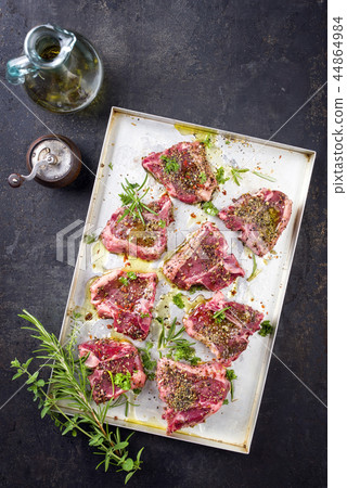 Raw T-Bone Lamb Steak with Seasonings as top view Raw T-Bone Lamb Steak with Seasonings as top view 44864984