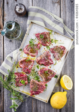 Raw T-Bone Lamb Steak with Seasonings as top view Raw T-Bone Lamb Steak with Seasonings as top view 44864985