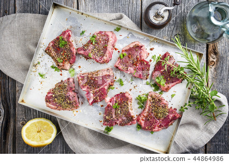 Raw T-Bone Lamb Steak with Seasonings as top view Raw T-Bone Lamb Steak with Seasonings as top view 44864986