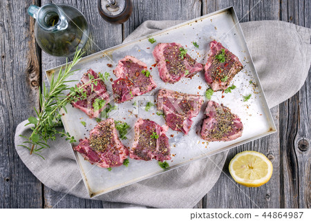Raw T-Bone Lamb Steak with Seasonings as top view Raw T-Bone Lamb Steak with Seasonings as top view 44864987