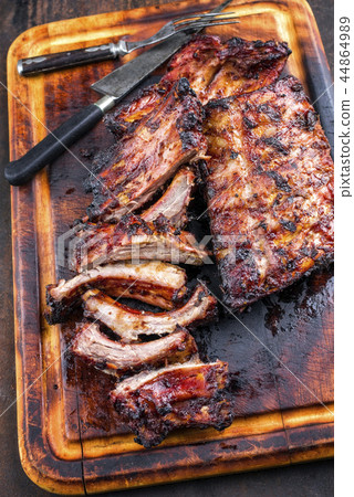 Barbecue Pork Spare Ribs as top view on a burnt cu 44864989