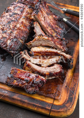 Barbecue Pork Spare Ribs as top view on a burnt cu Barbecue Pork Spare Ribs as top view on a burnt cu 44864990