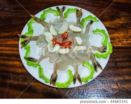 Shrimp in fish sauce with gour on hardwood table Shrimp in fish sauce with gour on hardwood table 44865341