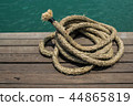 Rope on a hardwood floor above the sea. 44865819