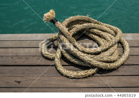 Rope on a hardwood floor above the sea. 44865819