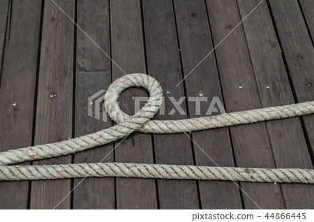 Ship rope on wooden plank floor. 44866445