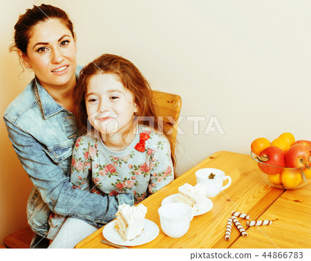 young mother with daughter on kitchen drinking tea together hugg young mother with daughter on kitchen drinking tea together hugg 44866783
