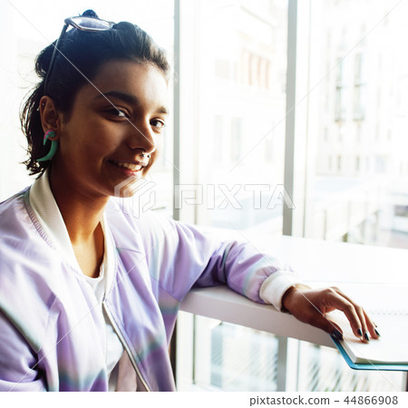 young cute hipster girl student sitting in cafe with notebook re 44866908