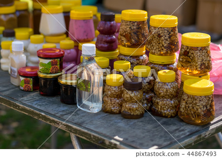different honey in plastic jars different honey in plastic jars 44867493