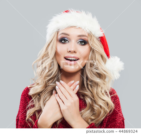 Happy excited woman in santa claus hat smiling 44869324