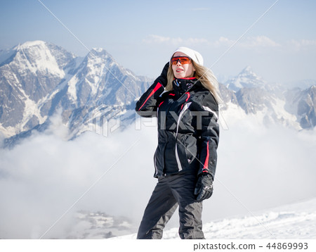 Young adult woman snowboarder holding snow board Young adult woman snowboarder holding snow board 44869993