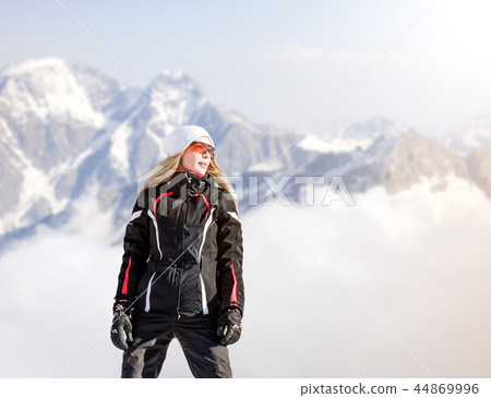 Young adult woman snowboarder holding snow board Young adult woman snowboarder holding snow board 44869996