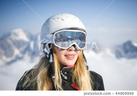 Young adult woman snowboarder or skier in snow 44869998