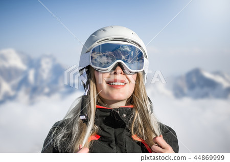 Young adult woman snowboarder or skier in snow Young adult woman snowboarder or skier in snow 44869999