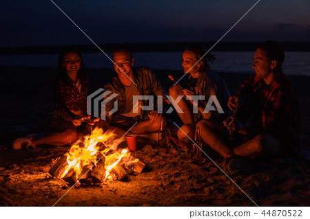 young friends have picnic with bonfire on the beach young friends have picnic with bonfire on the beach 44870522