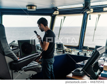 Marine navigational officer is reporting by VHF radio Marine navigational officer is reporting by VHF radio 44870541