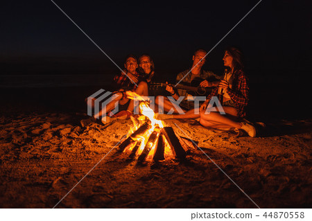 young friends have picnic with bonfire on the beach young friends have picnic with bonfire on the beach 44870558
