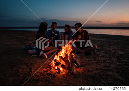 young friends have picnic with bonfire on the beach young friends have picnic with bonfire on the beach 44870563