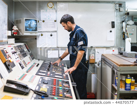 Marine engineer officer working in engine room Marine engineer officer working in engine room 44870577
