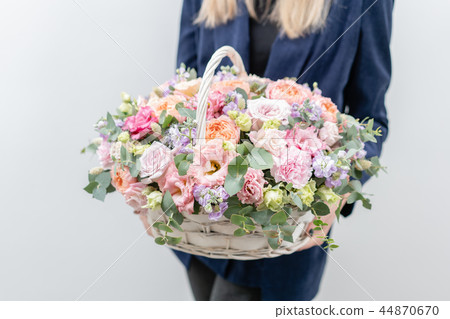 Beautiful spring bouquet in wicker basket. Arrangement with various flowers. The concept of a flower 44870670