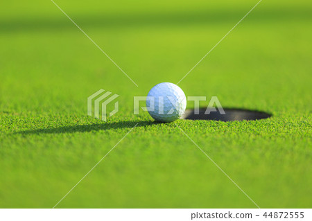 Cup and golf ball 44872555