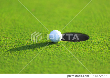 Cup and golf ball Cup and golf ball 44872556