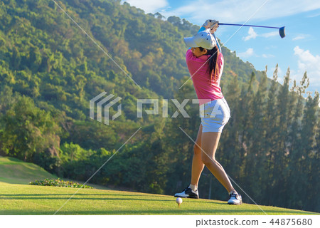 Asian woman golf player doing golf swing tee off  44875680
