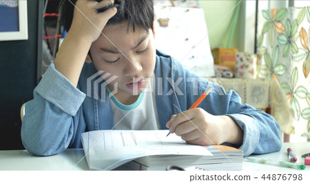 Asian child doing your homework at home. Asian child doing your homework at home. 44876798