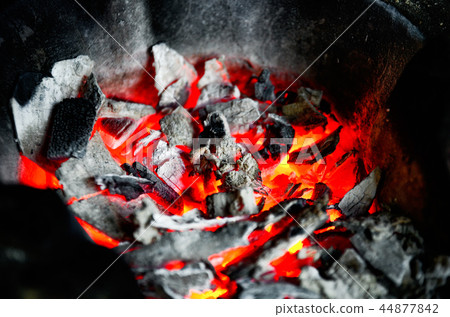 fire flames with sparks on the coals 44877842