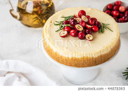 Classic New York Cheesecake with cranberry, rosemary and tea on White Concrete Background, copy Classic New York Cheesecake with cranberry, rosemary and tea on White Concrete Background, copy 44878363