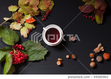yellow and Red fall leaves coffee cup nuts on a black background yellow and Red fall leaves coffee cup nuts on a black background 44880902