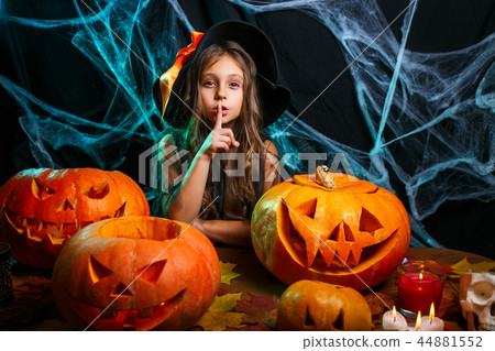 Happy Halloween . Little girl in witch costume celebrating Halloween doing silence gesture posing 44881552