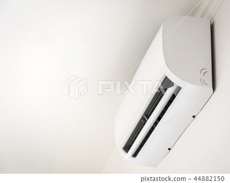 white air conditioner mounted on a white wall white air conditioner mounted on a white wall 44882150