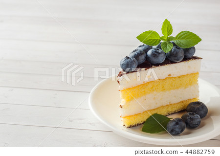 Cake of a souffle with glaze and fresh blueberries Cake of a souffle with glaze and fresh blueberries 44882759