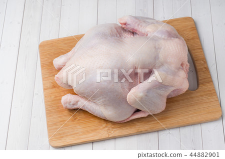 Fresh raw chicken on cutting board and spices Fresh raw chicken on cutting board and spices 44882901