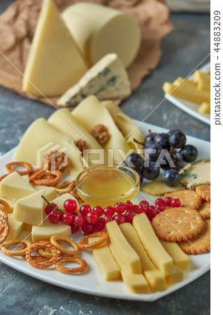 cheese platter on a plate with berries 44883209