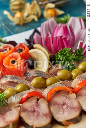 Plate with fish platter on blue background 44883248
