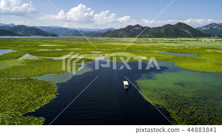 Aerial view of the beautiful landscape of Lake Skadar in the mountain on a sunny day. Montenegro Aerial view of the beautiful landscape of Lake Skadar in the mountain on a sunny day. Montenegro 44883841