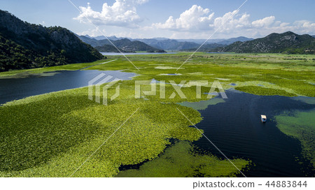 Aerial view of the beautiful landscape of Lake Skadar in the mountain on a sunny day. Montenegro Aerial view of the beautiful landscape of Lake Skadar in the mountain on a sunny day. Montenegro 44883844
