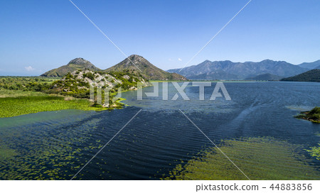 Aerial view of the beautiful landscape of Lake Skadar in the mountain on a sunny day. Montenegro Aerial view of the beautiful landscape of Lake Skadar in the mountain on a sunny day. Montenegro 44883856