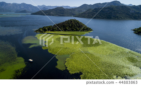 Aerial view of the beautiful landscape of Lake Skadar in the mountain on a sunny day. Montenegro Aerial view of the beautiful landscape of Lake Skadar in the mountain on a sunny day. Montenegro 44883863